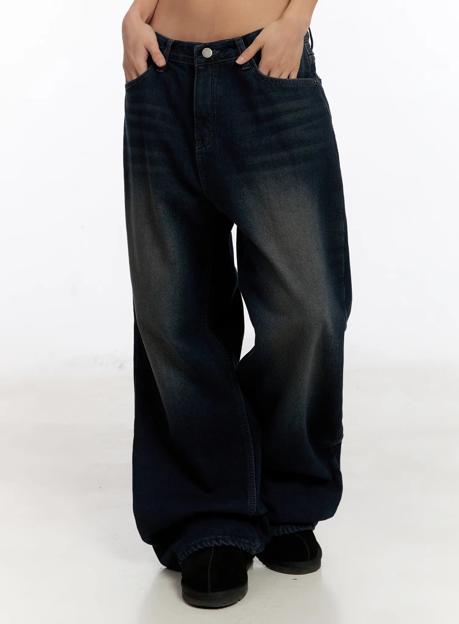 LEWKIN Auro Fleece-lined Wide Leg Jeans CN527 in dark blue, front side view on model, low-rise washed cotton wide-leg silhouette with faded wash, hands in pockets, pooling at ankle.