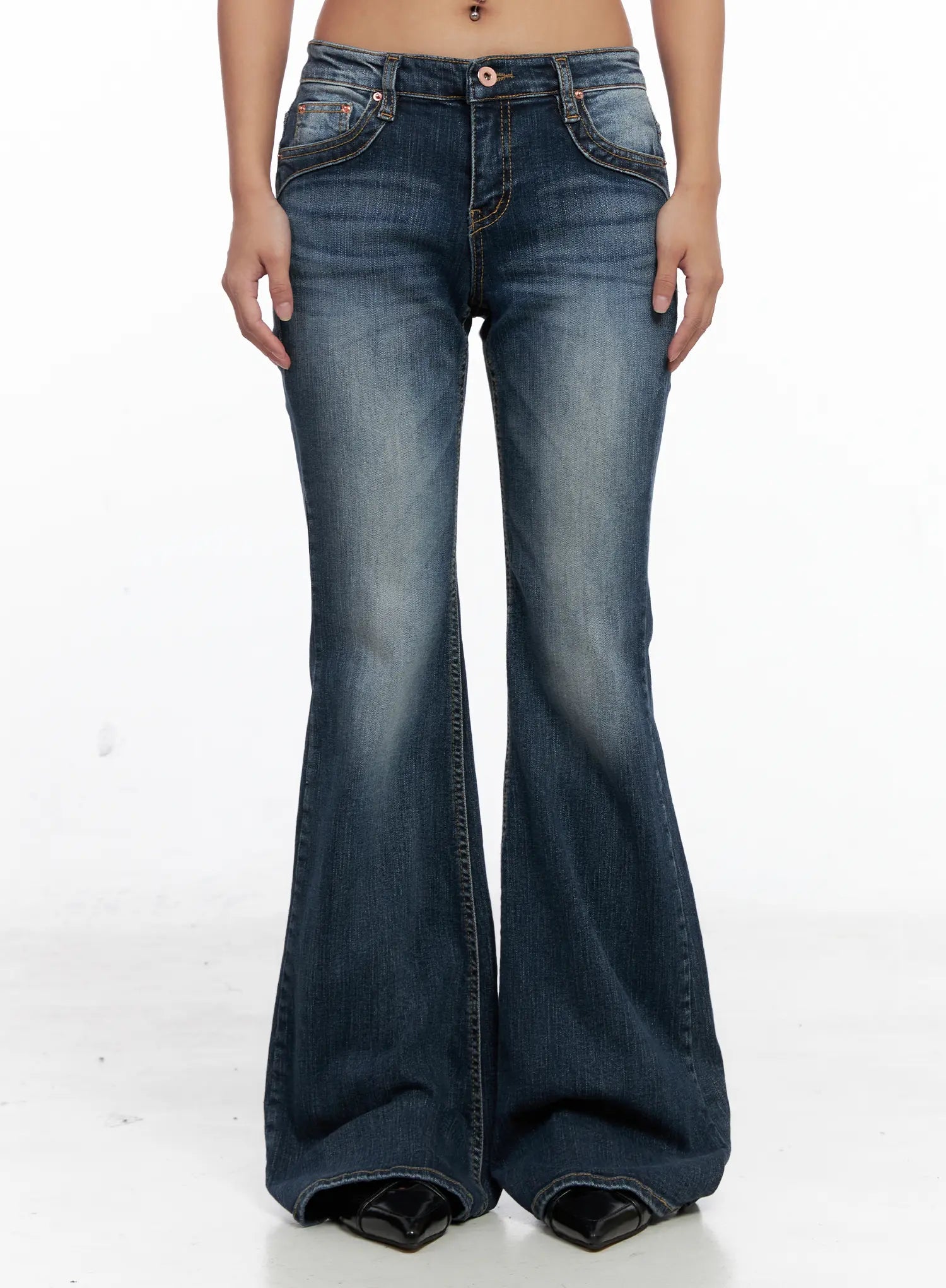 LEWKIN Saanvi Vintage Wash Flare Jeans CS522 in dark blue, front product shot on model, low-rise flare silhouette with vintage wash, contrast stitching, front pockets visible, paired with black heels.