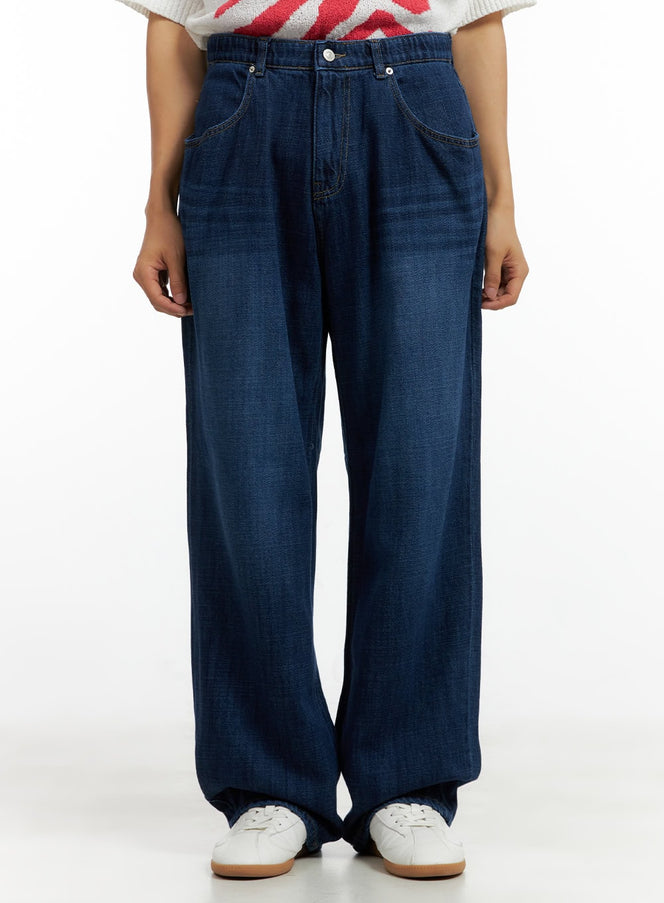 LEWKIN Men's Washed Cotton Denim Jeans CL429 in dark blue, front view on model, wide-leg silhouette with elastic waist, pleated front pockets, paired with white sneakers.