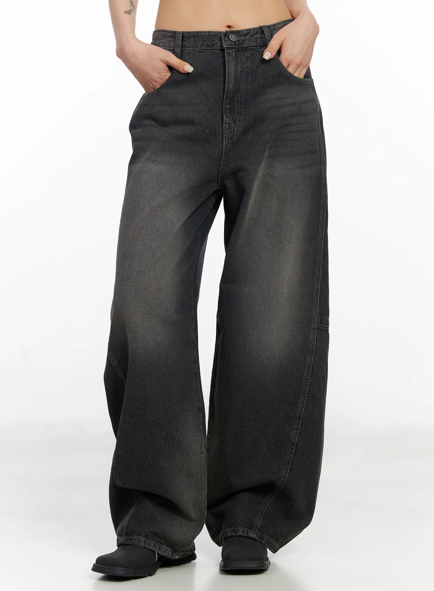 LEWKIN Nayeli Baggy Jeans CJ522 in dark gray, front waist-down shot on model, washed cotton wide-leg silhouette with front pockets, hands tucked in, paired with black boots.