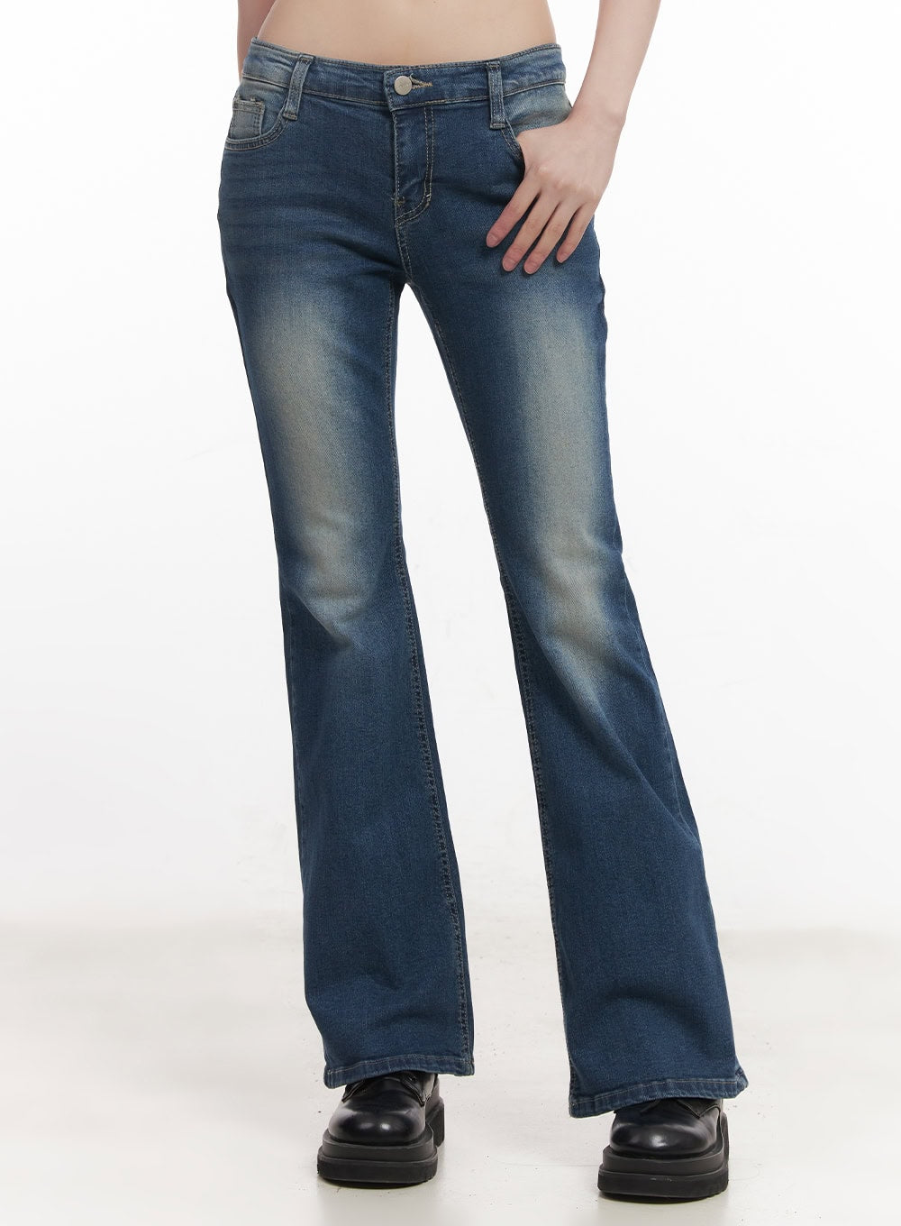 LEWKIN Rebecca Low-Waist Flared Jeans CM519 in dark blue, front cropped view on model, slim-fit bootcut with washed denim, low waist, worn with black chunky boots.