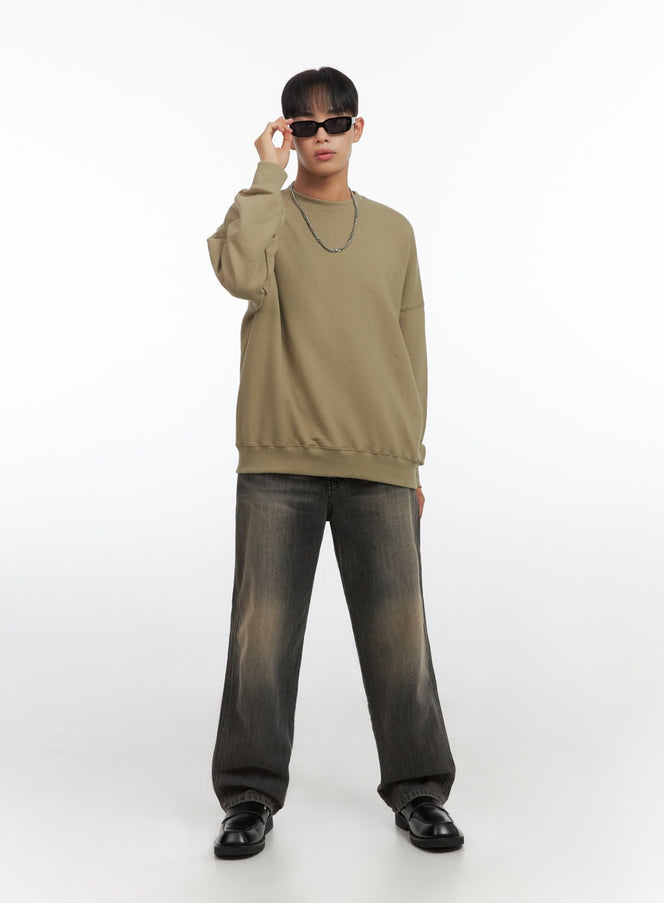 LEWKIN Men's Washed Wide Leg Jeans IO420 in black, full-body front view on model looking over sunglasses, wide leg silhouette with faded wash, paired with khaki oversized sweatshirt and black loafers.