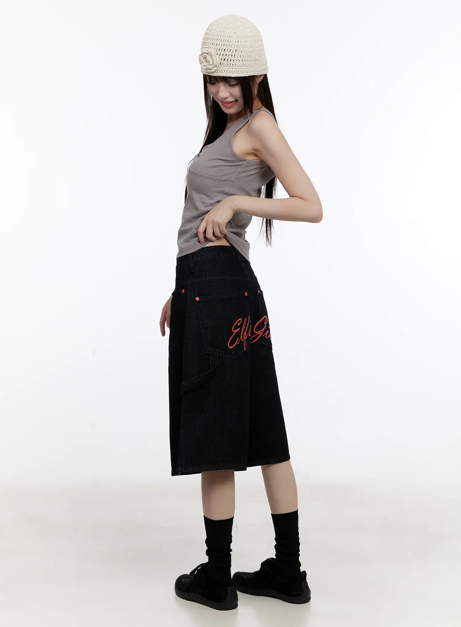 LEWKIN Red Text Graphic Embroidered Jorts CL504 in black, side view on model, wide-leg cotton denim, red script embroidery visible, paired with gray tank and knit hat.