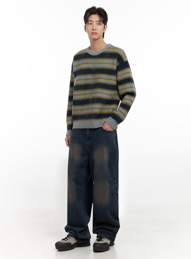 LEWKIN Men's Relaxed-Fit Jeans ID406 in dark washed blue, full-body front angle on model, wide-leg silhouette with faded whisker detail, paired with striped knit sweater and chunky sneakers.
