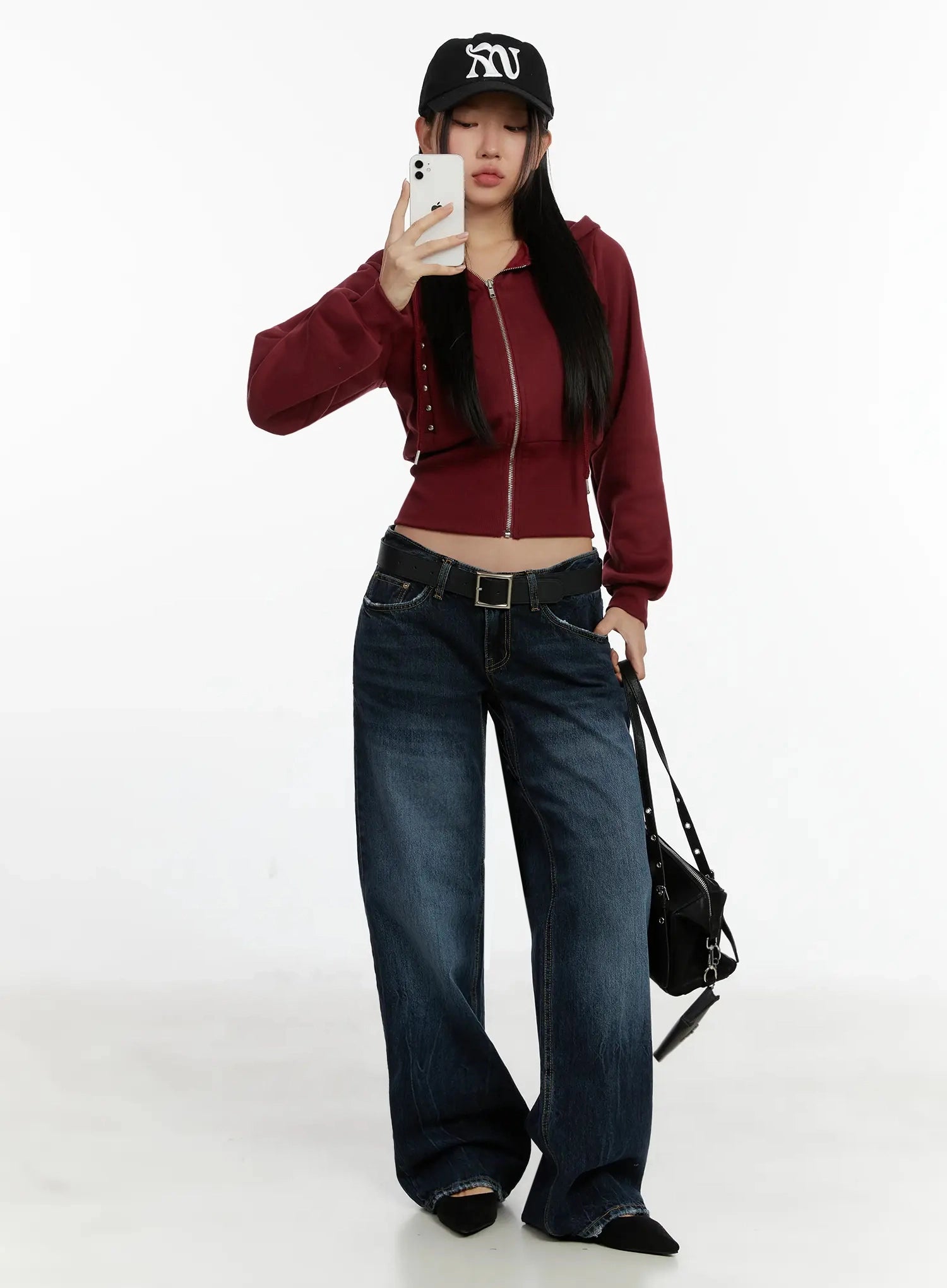 LEWKIN Aimee Low Rise Wide Leg Jeans ID525 in dark blue wash, full-length mirror selfie on model, low-rise waistband with gold stitching, styled with burgundy zip hoodie, black belt, and mini bag.