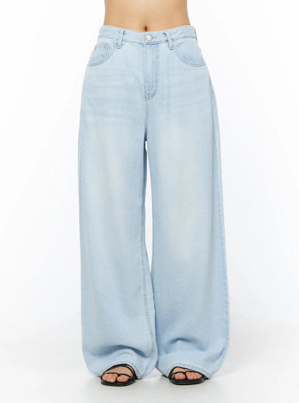 LEWKIN Rina Washed Wide-Leg Jeans CU522 in light blue, front view on model (waist-down), relaxed wide-leg silhouette with washed denim finish, paired with black sandals.