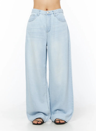 LEWKIN Rina Washed Wide-Leg Jeans CU522 in light blue, front view on model (waist-down), relaxed wide-leg silhouette with washed denim finish, paired with black sandals.