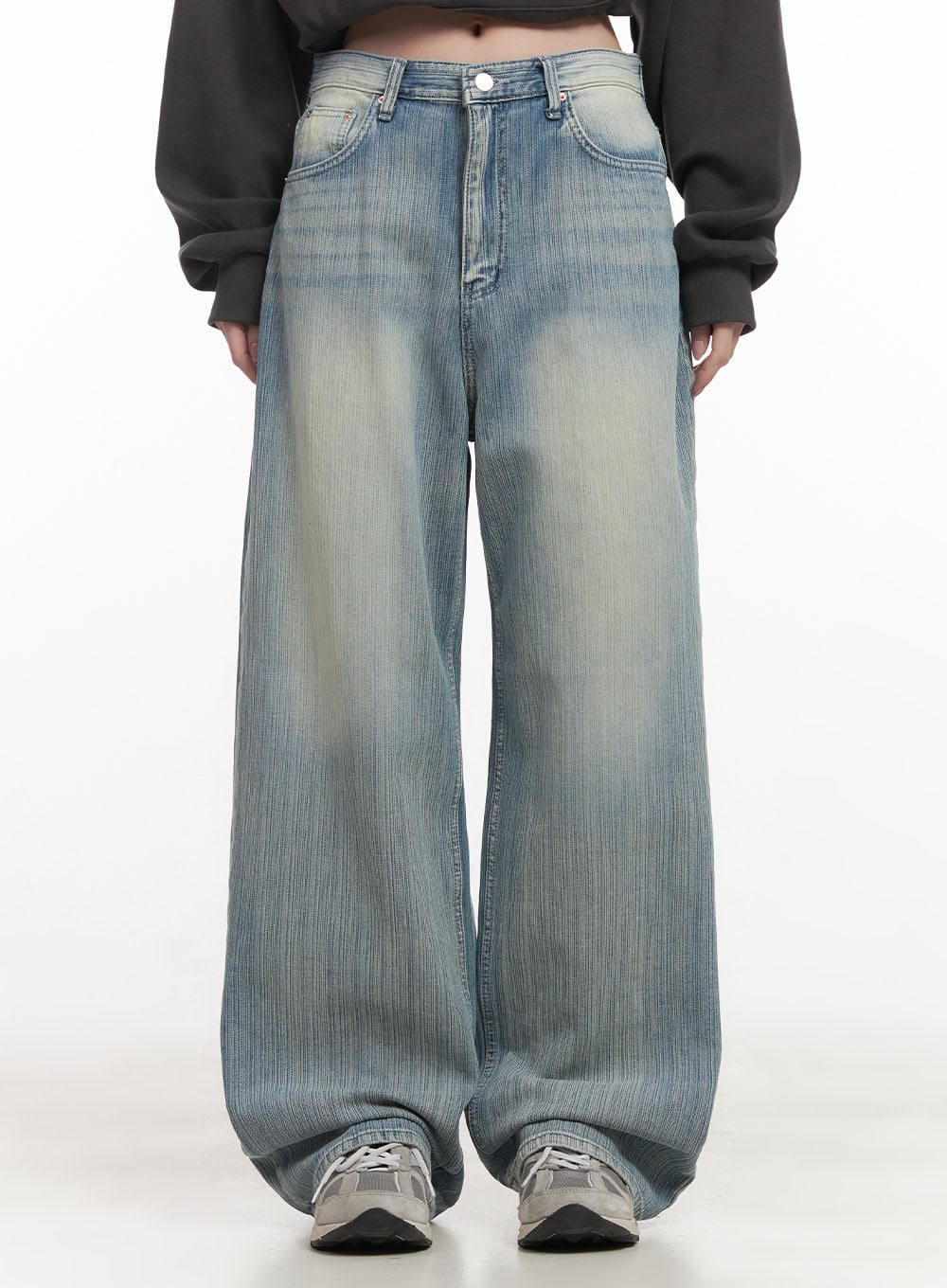 LEWKIN Nicola Washed Wide-Leg Jeans CF514 in light blue, front crop view on model, washed cotton denim with faded whisker detail, wide-leg silhouette pooling at sneakers.
