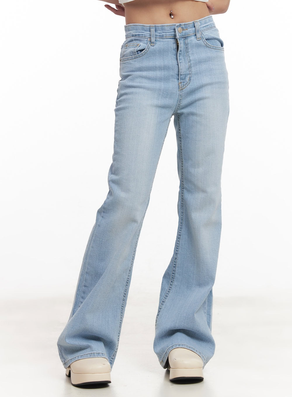 LEWKIN Suzy Slim-Fit Bootcut Jeans CM505 in light blue, front three-quarter product shot on model, slim-fit washed denim with bootcut flare hem, paired with white platform clogs.