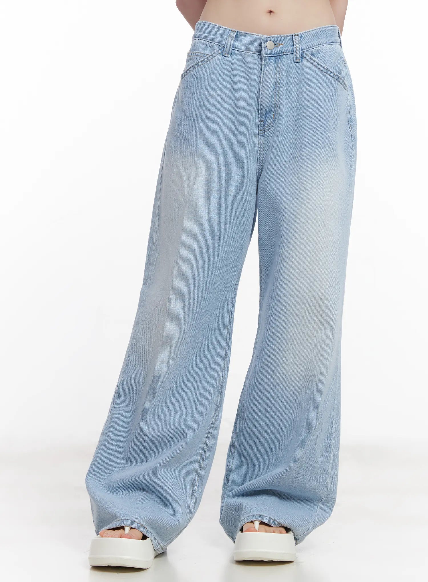 LEWKIN Haerin Washed Wide-Leg Jeans CU519 in light blue, front close-up on model, washed cotton denim, wide fit with angled front pockets and button closure, paired with white sandals.