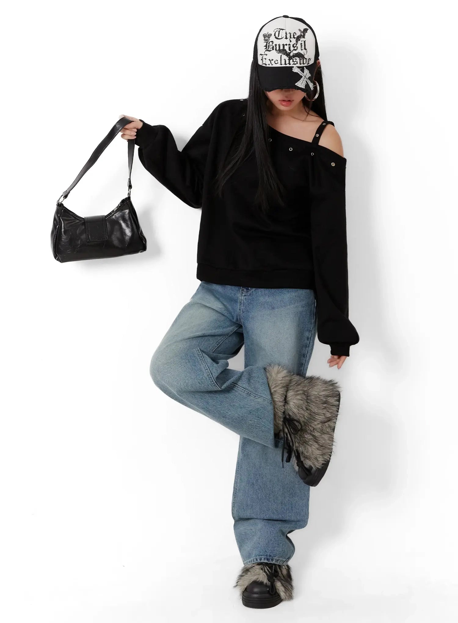 Pixi Straight Leg Jeans ID525 in blue, full-body editorial shot on model in dynamic pose, long straight leg washed denim, styled with black off-shoulder sweatshirt, cap, shoulder bag, and fur-trim boots.