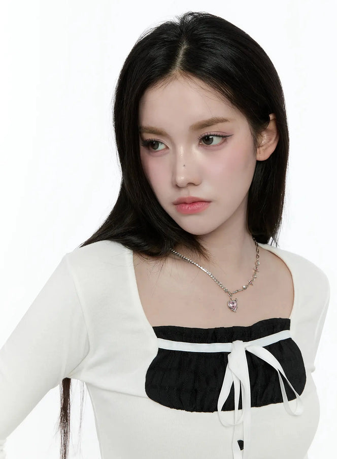 Double Chain Heart Pendant Necklace IO527 in Silver, front portrait on model, double-chain design with pink heart pendant visible at collarbone, styled with white square-neck top.