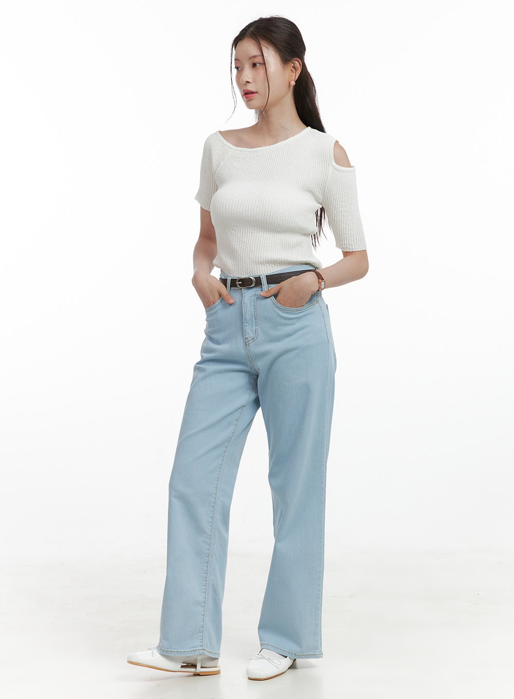 Washed Low Rise Loose Straight Jeans OL416 in light blue, 3/4 angled full-body shot on model, loose straight cotton denim with belt, paired with white cold-shoulder ribbed knit top and white loafers.