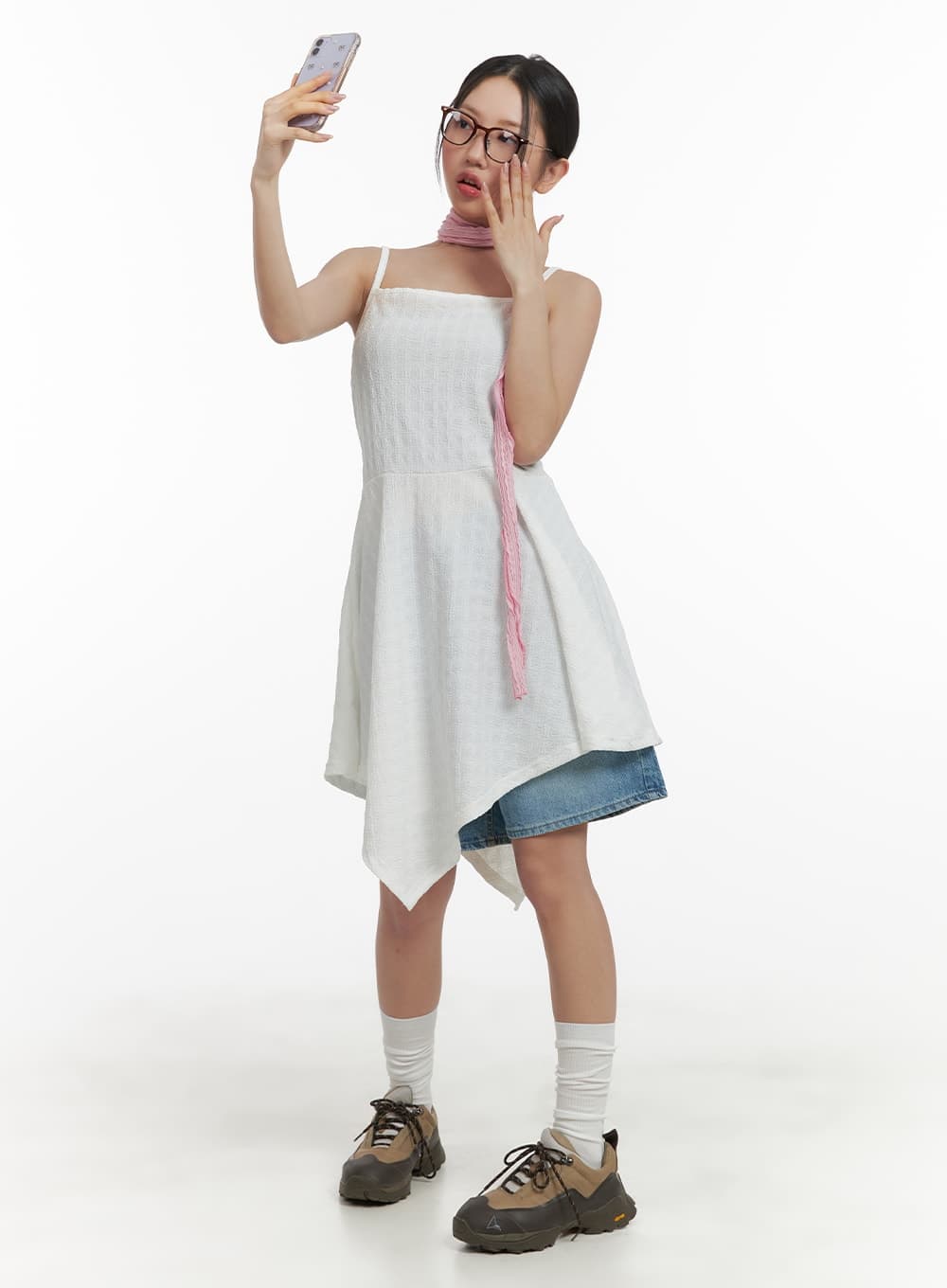 Washed Wide Leg Jorts CA409 in blue, full-body editorial shot, model posing with phone, layered under asymmetric white slip dress with pink scarf accent.