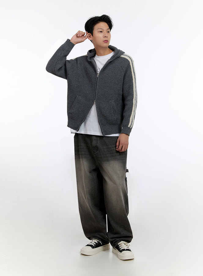 Men's Striped Double Zipper Knit Hoodie IO428 in dark gray, full-body front view on model, arm raised, cream sleeve stripes visible, styled with baggy washed jeans and canvas sneakers.