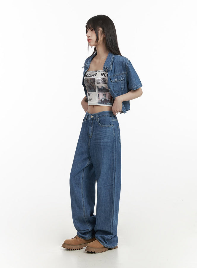 Solid Low Rise Baggy Jeans CY407 in blue, side full-body shot on model, wide-leg washed denim with low waist, styled with denim crop jacket and graphic tube top, tan boots.