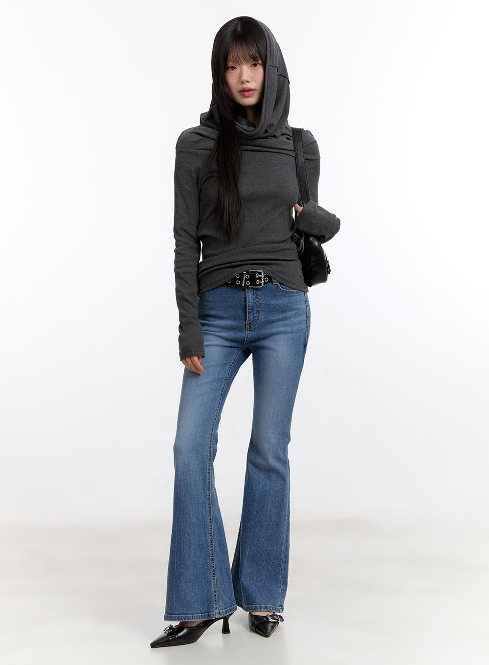 Maris Hip-Pad Bootcut Jeans CA508 in blue, full-body front shot on model, slim washed denim bootcut silhouette styled with grey hoodie, studded belt, and black bag.