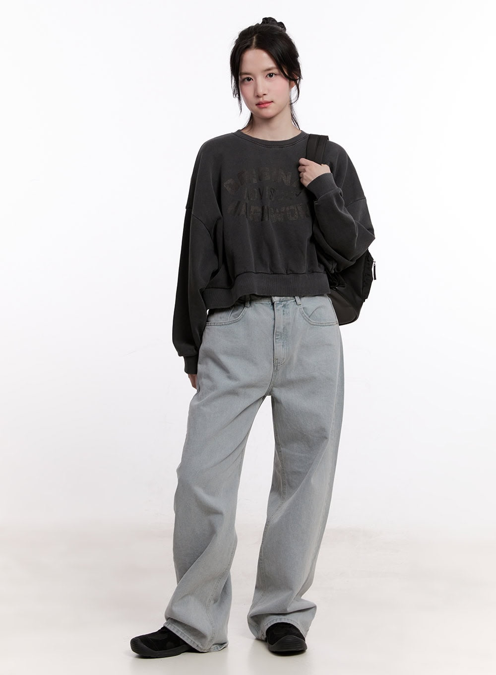 Casey Washed Baggy Wide-Leg Jeans CM526 in light gray, full-body front shot on model, wide-leg washed denim styled with charcoal crop sweatshirt and black backpack.