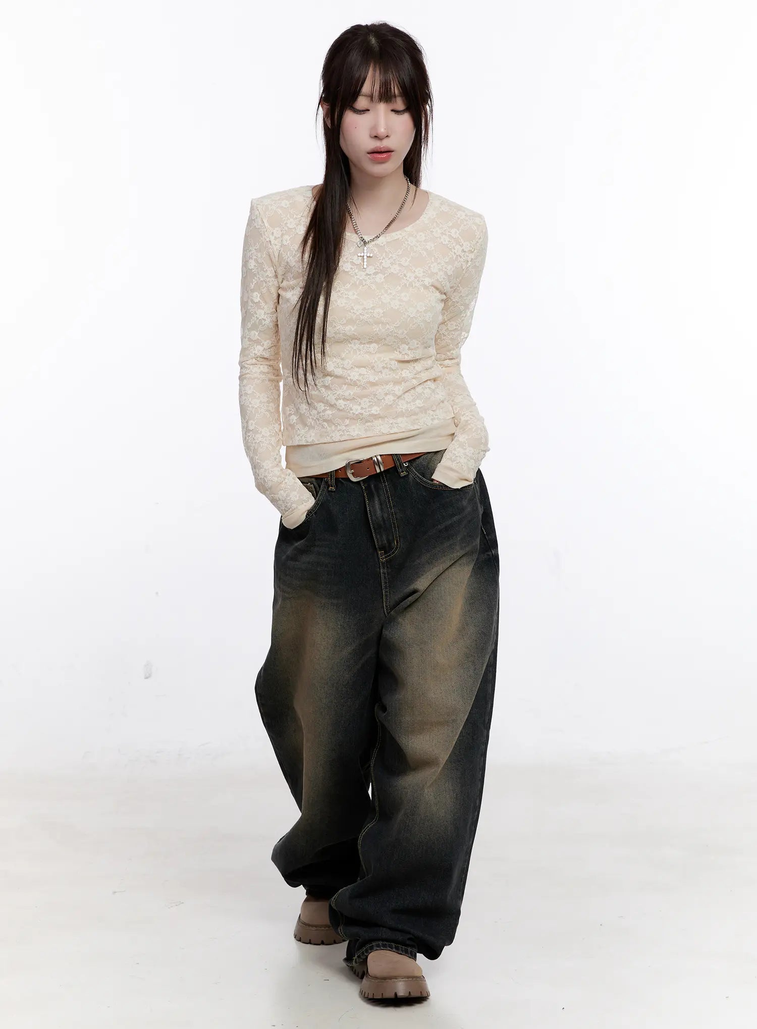 Sylvia Vintage Washed Baggy Jeans CO501 in dark blue, full-body front on model looking down, hands in pockets, styled with cream lace long-sleeve top and brown belt, street acubi look.