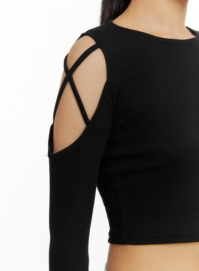 X-Strap Cut-Out Crop Top IA417 in black, close-up detail of crossed X-strap shoulder cut-out, slim ribbed fabric with visible strap construction and open shoulder.