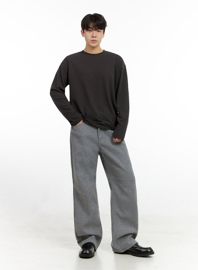 Men's Essential Solid T-Shirt IN422 in dark gray, full-body front on model, relaxed fit long sleeve, styled with gray wide-leg trousers and black loafers.