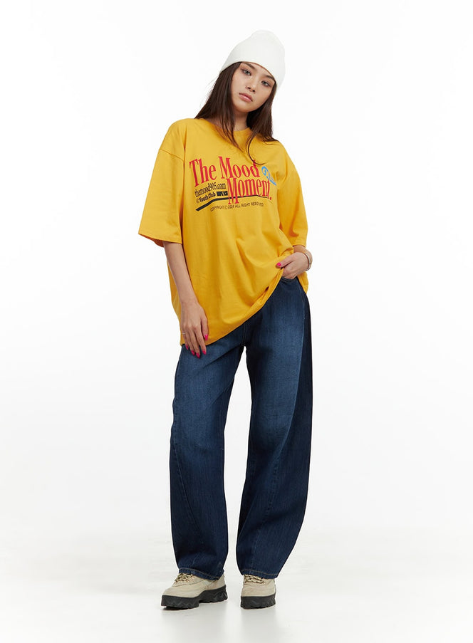 Low Rise Loose fit Baggy Jeans CU417 in blue, full-body front on model, wide baggy leg washed denim, styled with oversized yellow graphic tee and white beanie.
