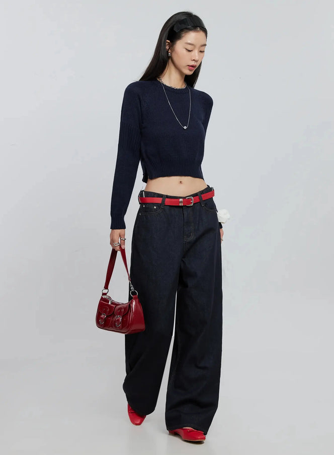 Side Button Cropped Knit IO530 in dark blue, full-body editorial shot on model, styled with dark wide-leg jeans, red belt, red bag, and silver necklace.