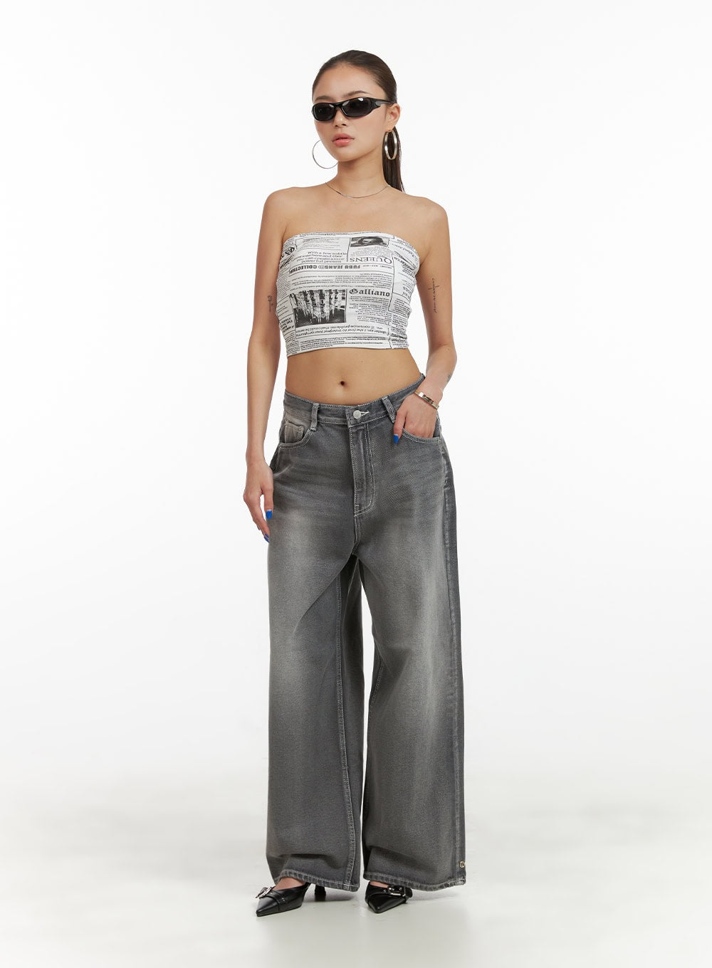 Low Rise Baggy Jeans CY431 in gray, full-body front shot on model, wide-fit washed denim styled with newspaper-print tube top and black heels.