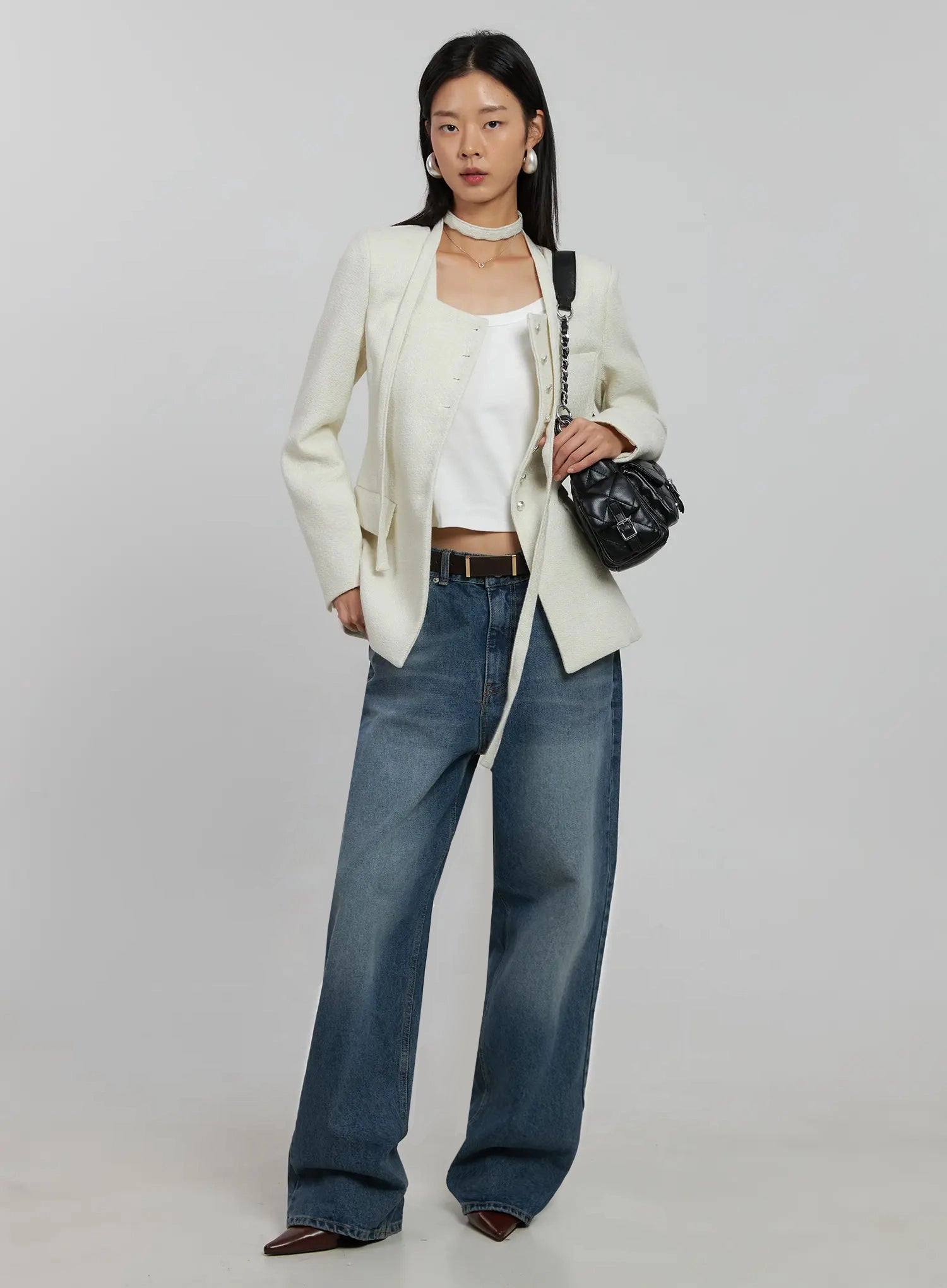 Akira Wide Leg Jeans IJ508 in blue, full-body front on model, styled with cream tweed blazer, white crop cami, brown belt, and black shoulder bag.