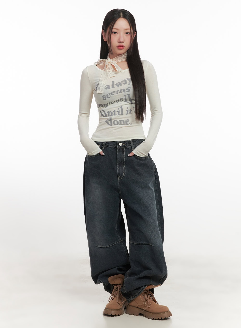 Giselle Stitched Balloon-Fit Jeans CF526 in dark blue, full-body front view on model, ultra-wide balloon fit pooling at hem, styled with graphic long-sleeve top and lace neck tie.