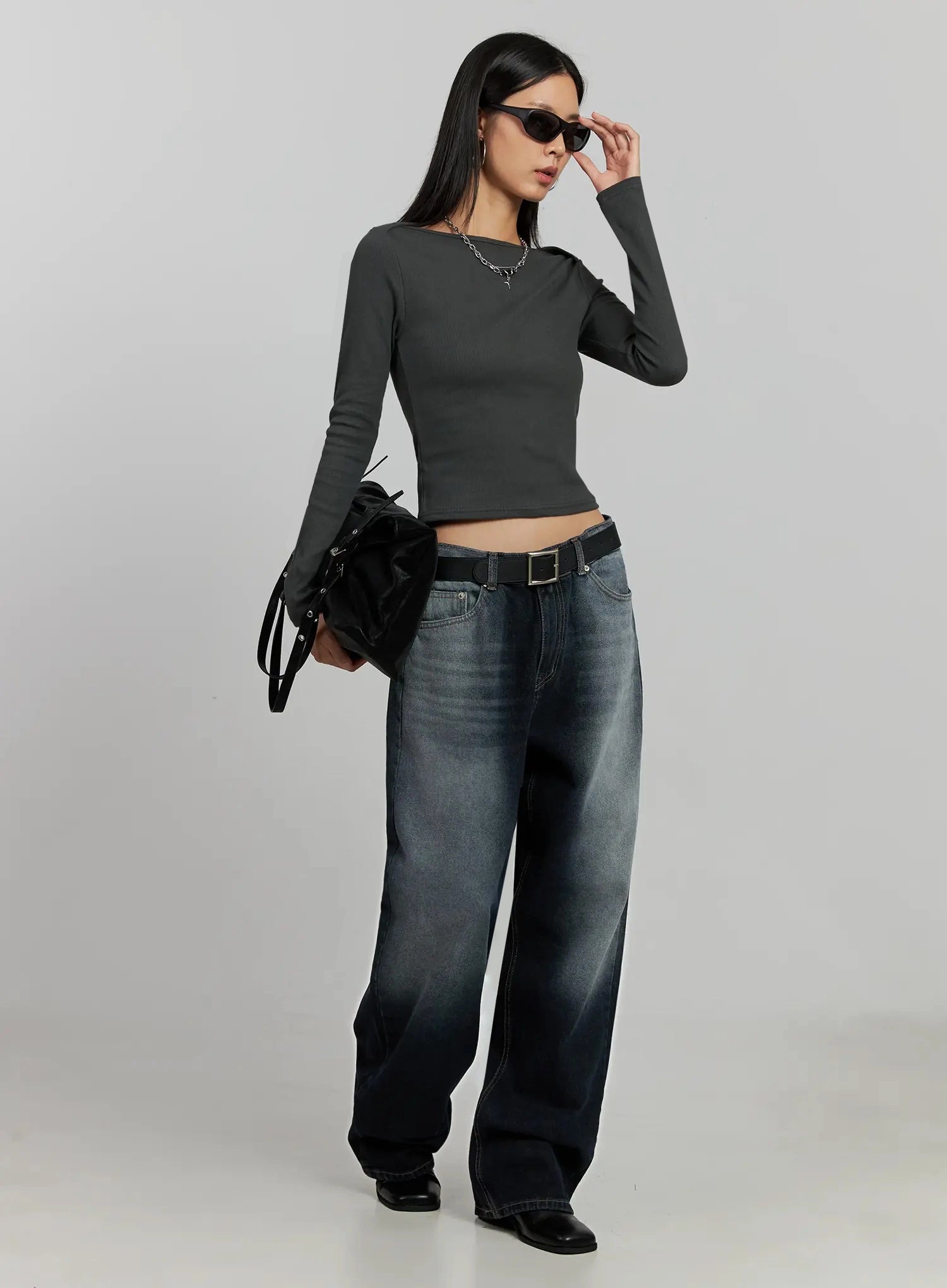 Chaya Washed Wide Jeans IJ505 in dark blue, full-body angled shot on model, styled with grey crop top, black belt and bag, sunglasses, acubi casual look.