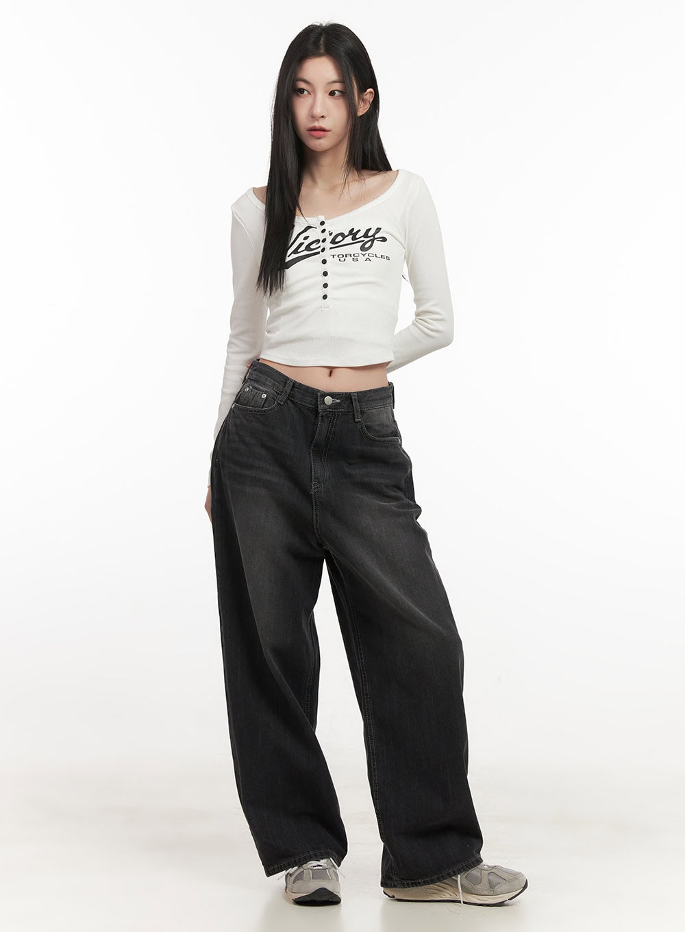 Ruth Washed Wide-Leg Jeans CF514 in black, full-length front view on model, baggy wide-leg silhouette, styled with white graphic crop long-sleeve and chunky sneakers.