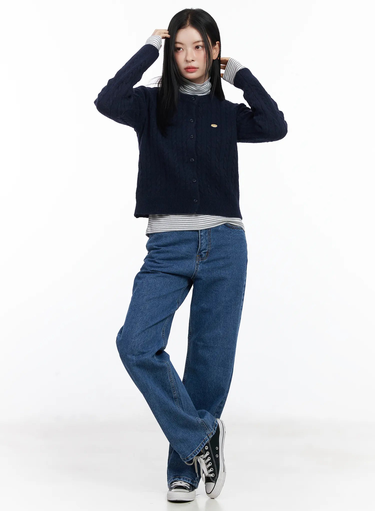 Aila Relaxed Fit Jeans CJ519 in blue, full-body front shot on model, relaxed wide-leg silhouette, styled with navy cable-knit cardigan and striped turtleneck.