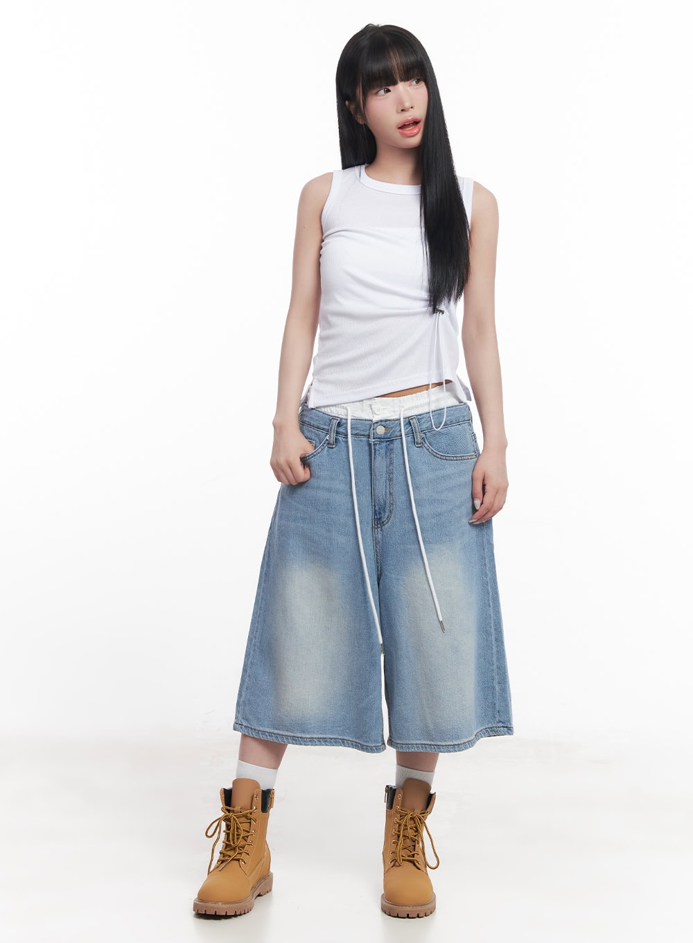 Layered Drawstring Baggy Jorts CY527 in light blue, full-body front on model, oversize wide-leg washed denim jorts with white layered waistband, paired with white sleeveless top and tan lace-up boots.