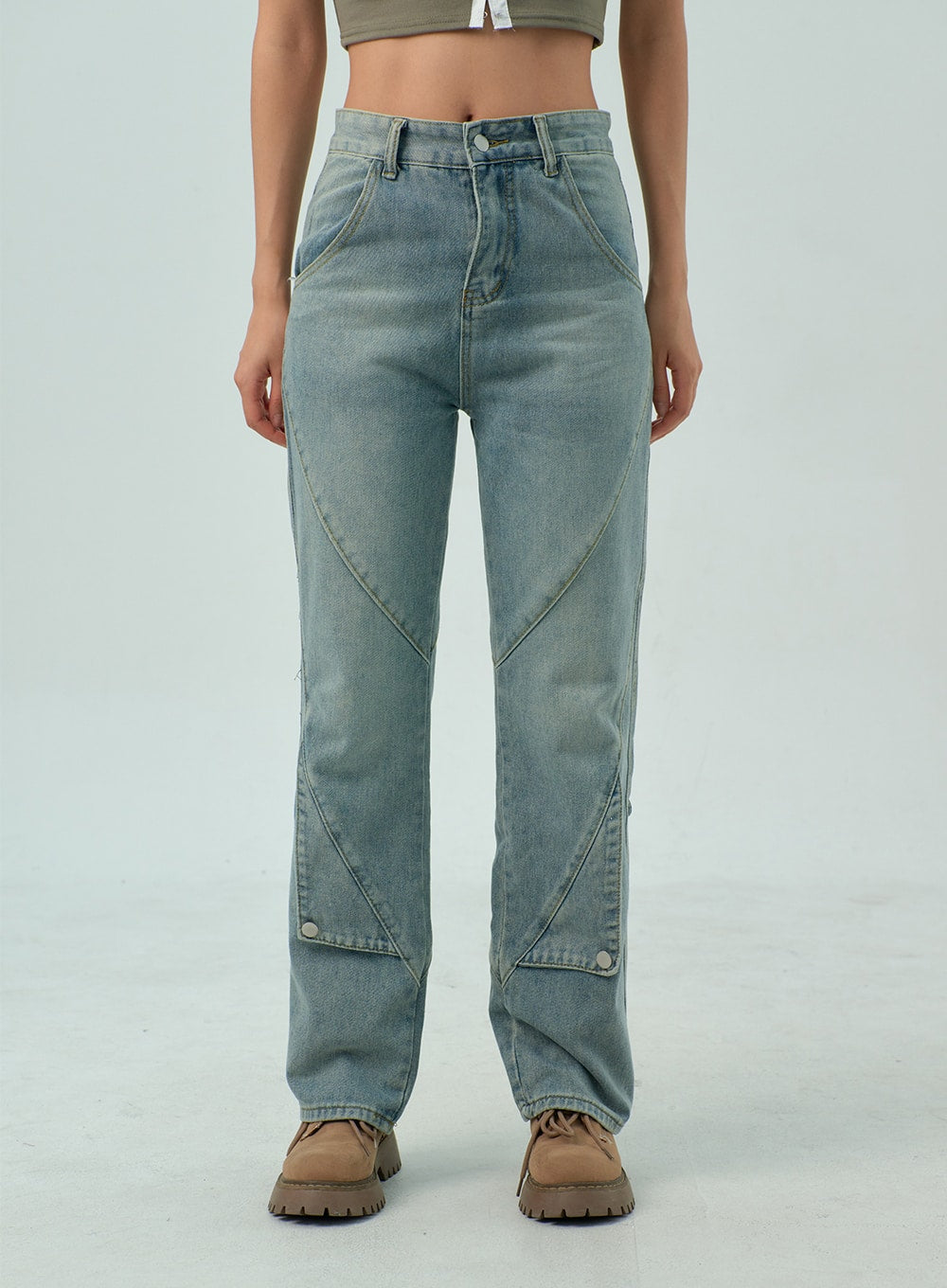 Straight Leg Jeans CY330 in light blue wash, front close-up on model from waist to ankle, straight fit with diagonal panel stitching, button detail at lower leg, worn with tan boots.
