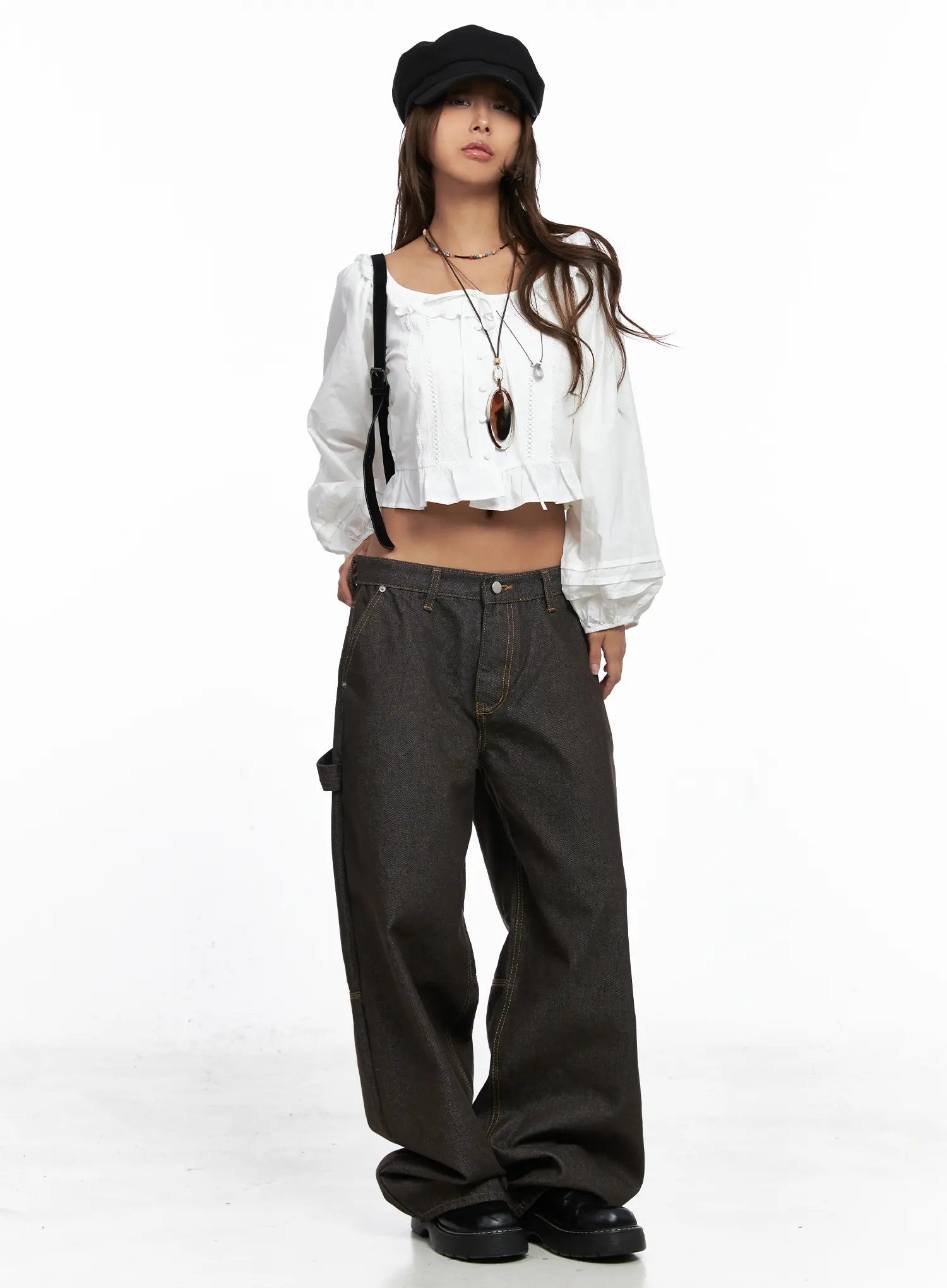 Oaklyn Non-Fade Wide-Leg Jeans CO513 in dark brown, full-body front shot on model styled with white ruffle crop top, black baker boy hat, crossbody bag, and layered necklaces.