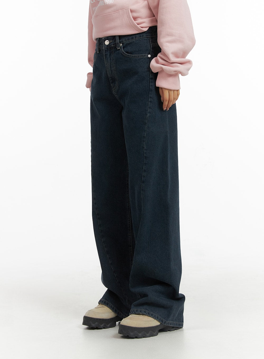 Washed Wide Leg Jeans CJ429 in dark blue, side view on model showing relaxed wide leg silhouette and deep inseam, styled with pink hoodie and chunky sneakers.