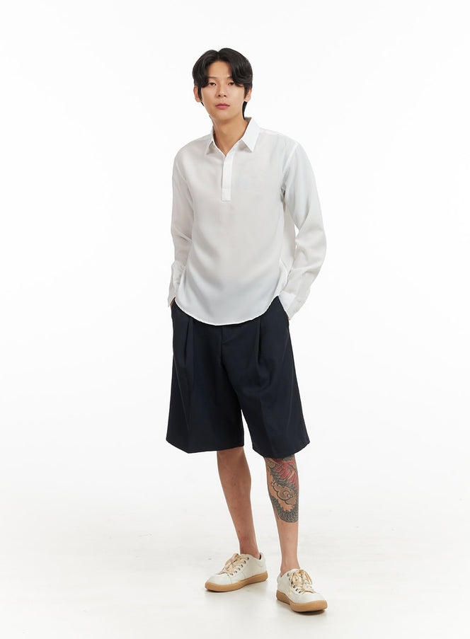 Men's Collared Long Sleeve Shirt IY416 in white, full-body front shot on model, relaxed fit with curved hem, styled with navy bermuda shorts and white sneakers.