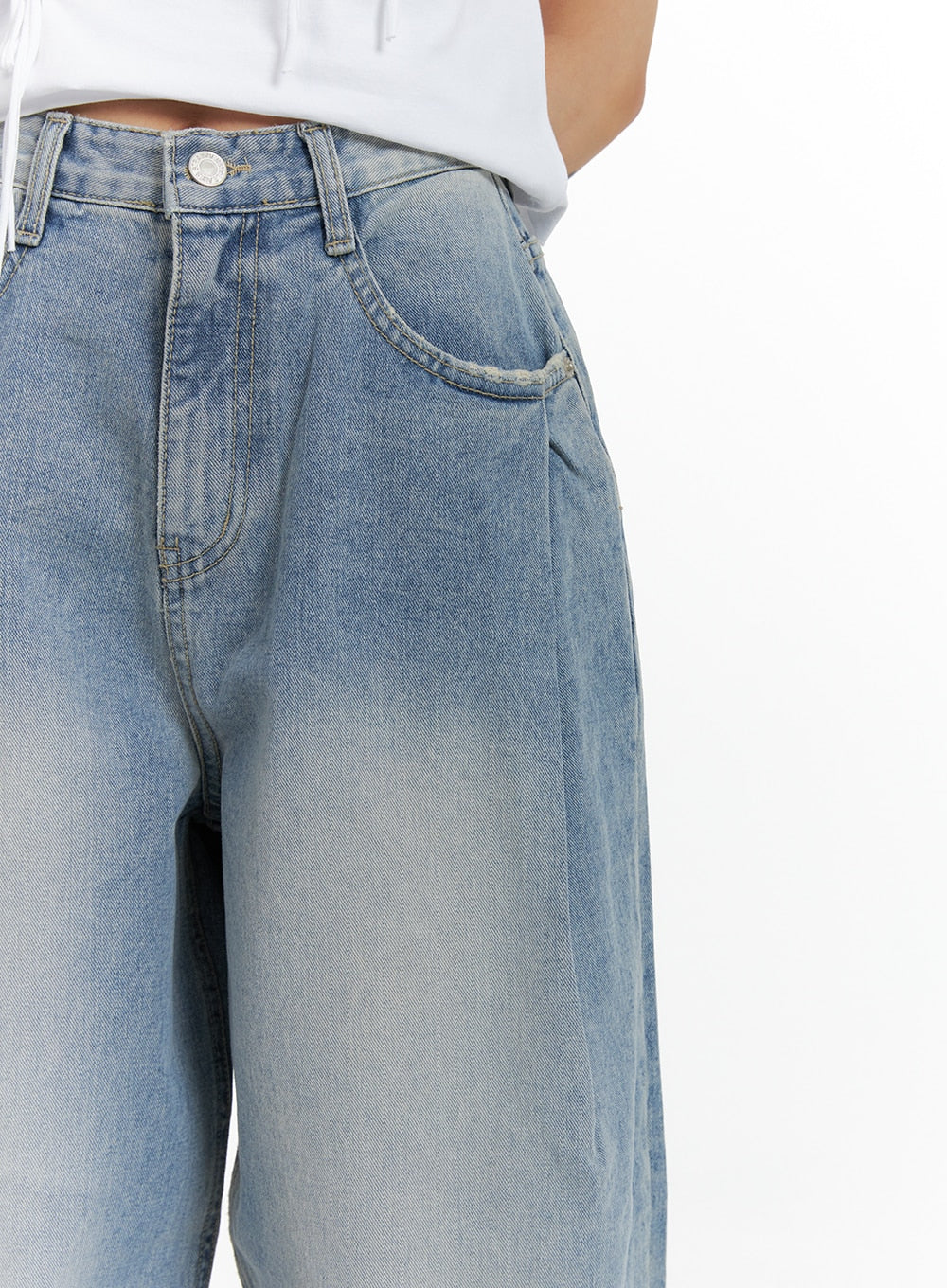 Wide Leg Baggy Jeans CM405 in light blue wash, close-up of waist and hip area on model, showing pintuck pleats, front pockets, and silver button detail.