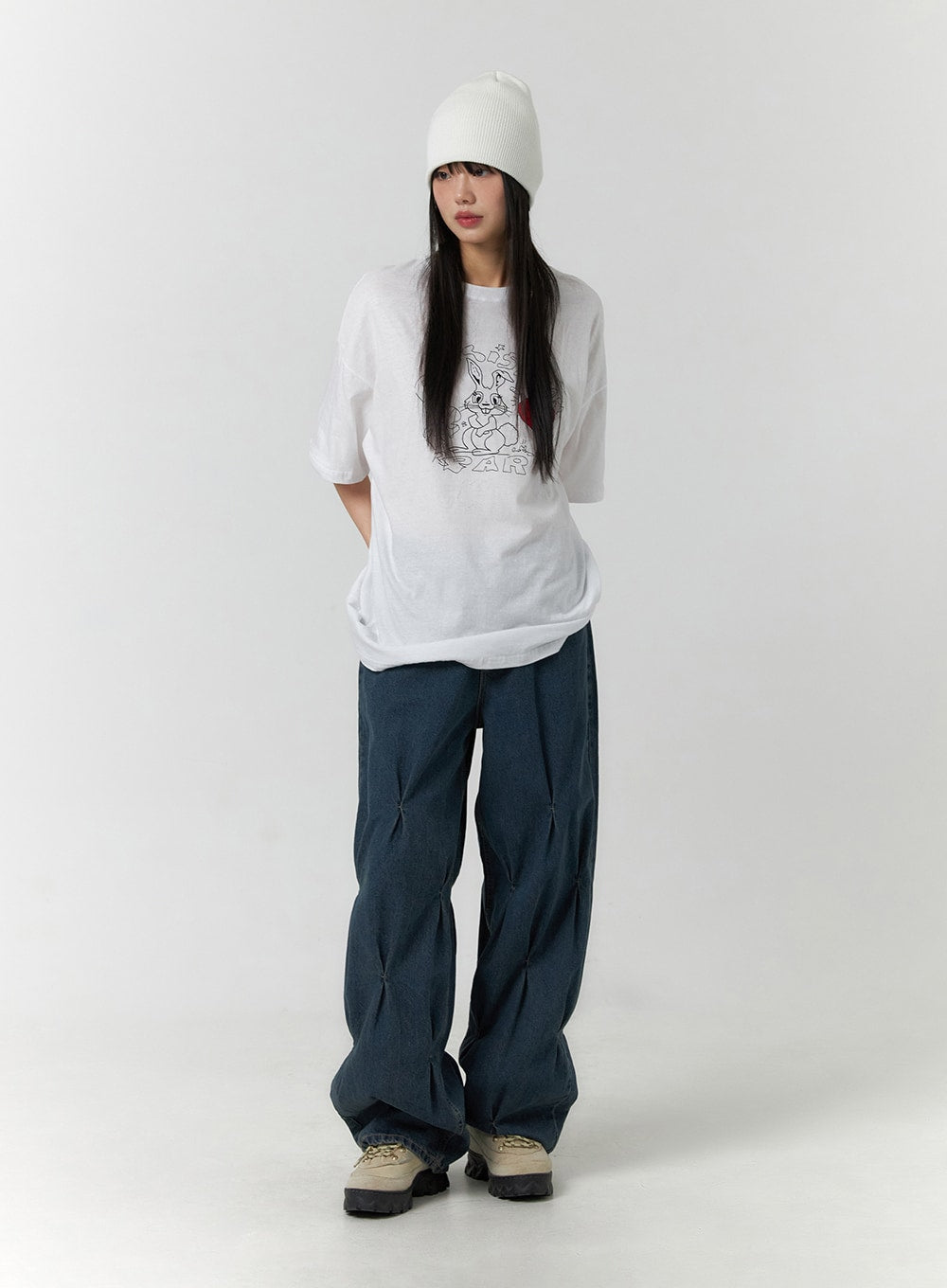 Quilted Wide Leg Denim CF406 in dark blue, full-length front shot on model, oversized silhouette with quilted pintuck panels, styled with white graphic tee and white ribbed beanie.