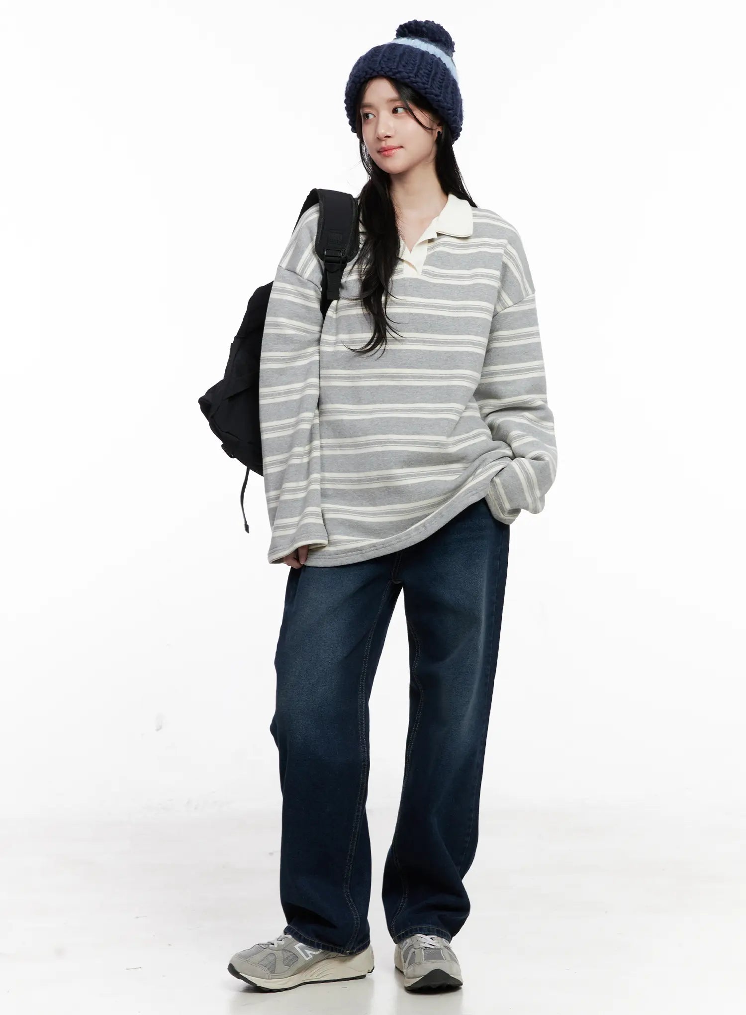 Shiloh Washed Semi-Wide Jeans CO524 in dark blue, full-body styling shot on model wearing striped polo top, knit beanie, and backpack, casual wide-fit look.