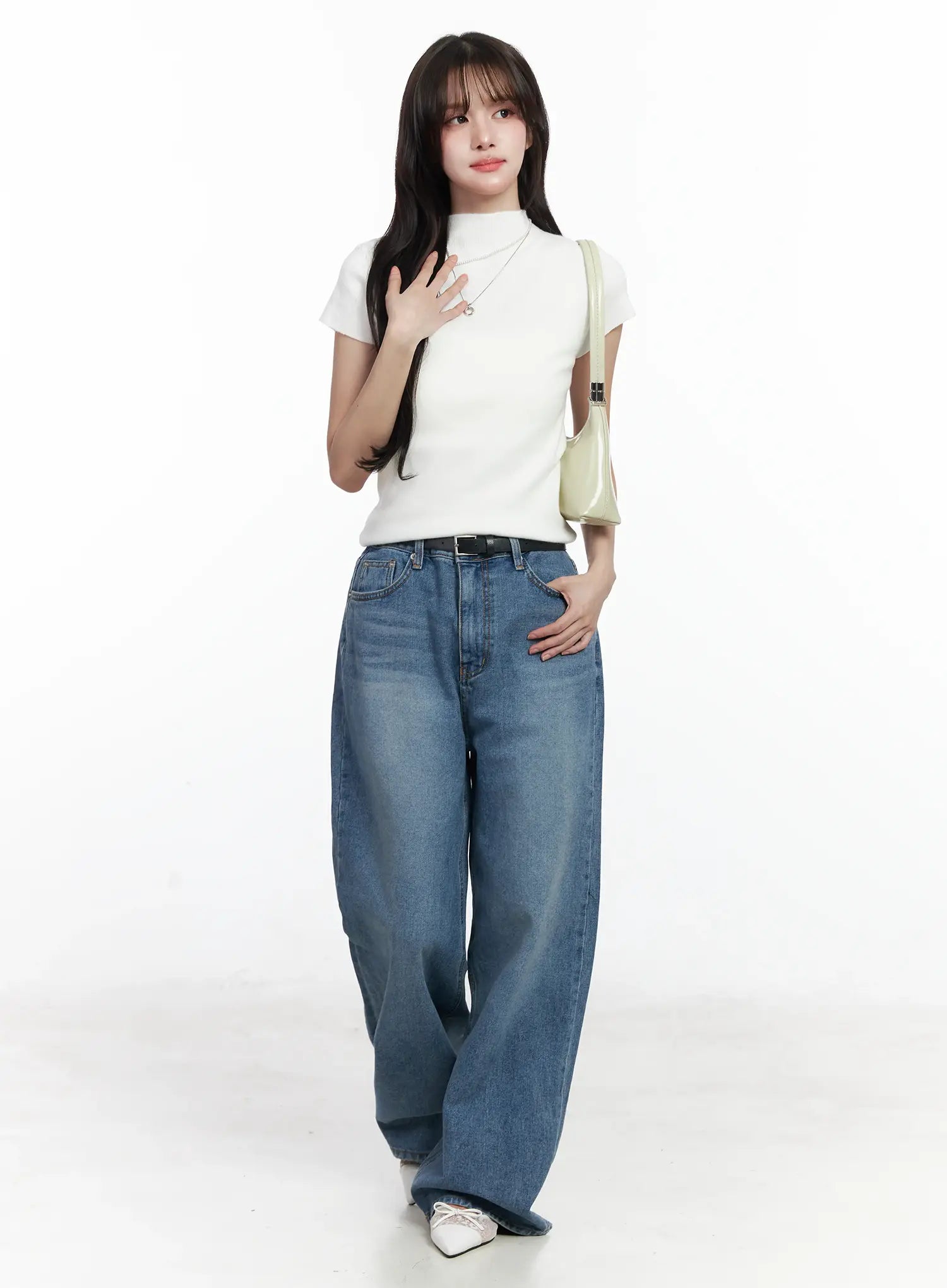 Ensley Wide Leg Jeans IJ529 in blue, full-body outfit shot on model, paired with white mock-neck tee, black belt, and green shoulder bag, casual acubi style.