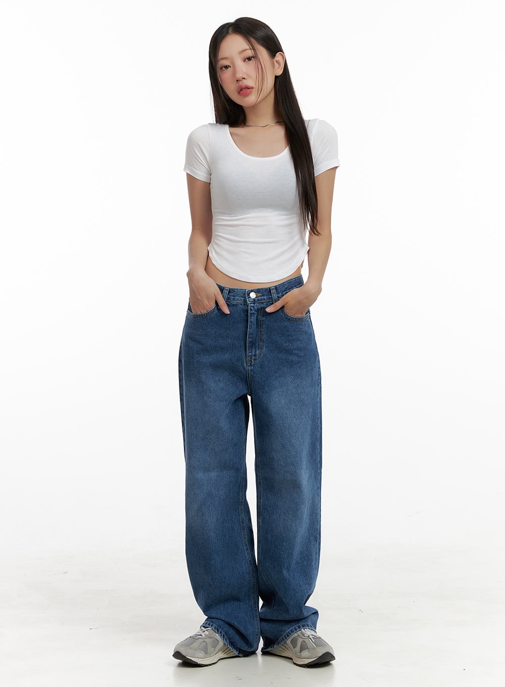 Eva Blue Washed Baggy Jeans CL431 in blue, full front view on model, wide-fit washed denim with relaxed baggy leg, styled with white fitted crop tee and grey sneakers.