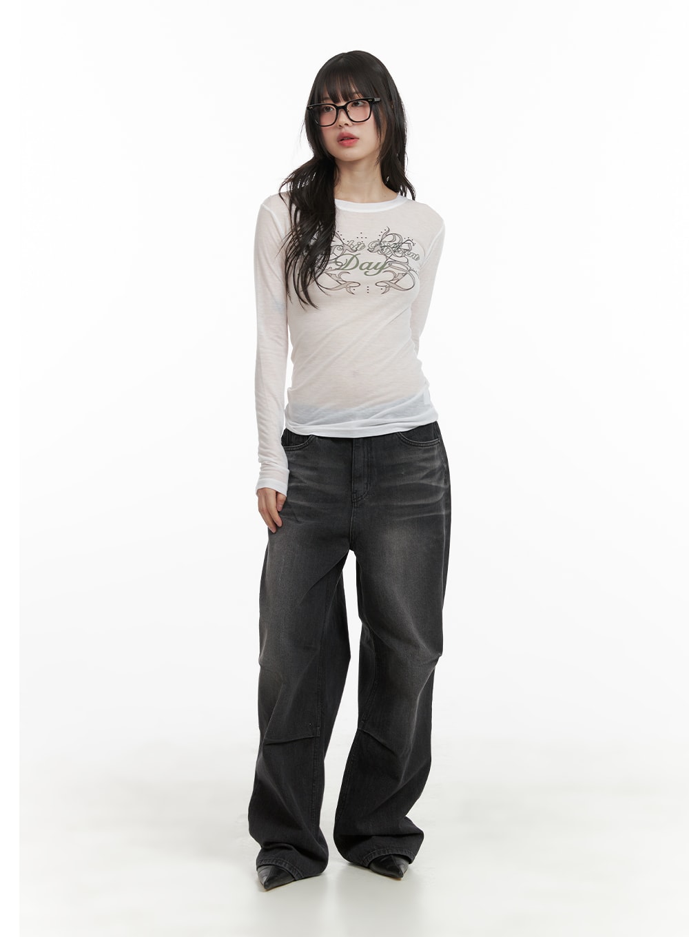 Pintuck Washed Denim Wide Leg Jeans CA419 in black, full-body front shot on model, relaxed wide-leg silhouette in washed denim, styled with graphic mesh long-sleeve top and black pointed boots.