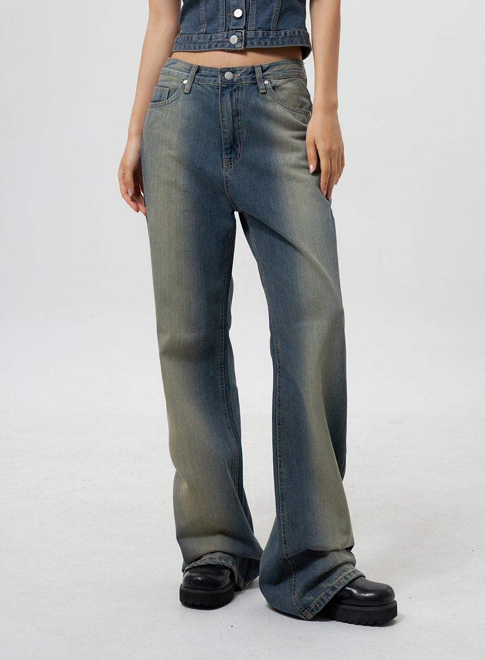 Low Rise Wide Leg Jeans CY323 in vintage blue, front close-up on model, low-rise waistband with silver button, wide-leg cut with yellow fade wash, paired with denim crop top and black boots.