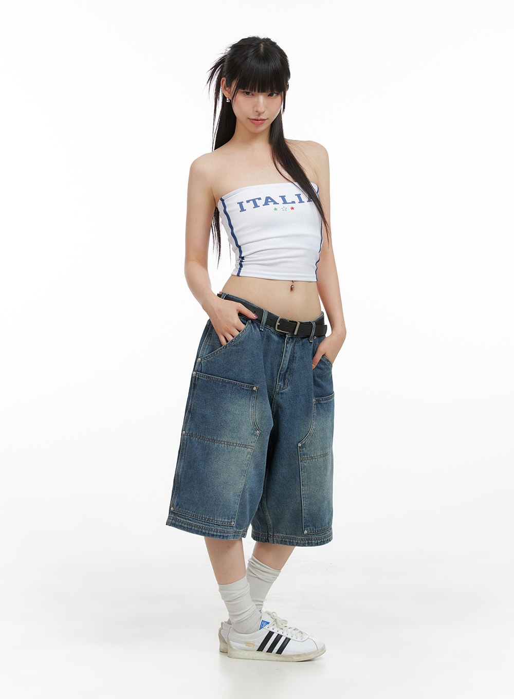 Stud Washed Baggy Jorts (UNISEX) CG408 in blue, full-body front on model, wide-fit half-length denim styled with white Italia tube top, black belt, and Adidas sneakers.