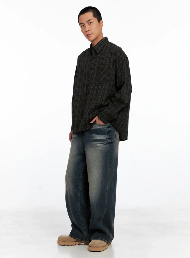 Men's Checkered Button Up Shirt IS510 in Black, three-quarter side view on model, full-length shot showing oversized silhouette, paired with wide-leg jeans and tan chunky shoes.