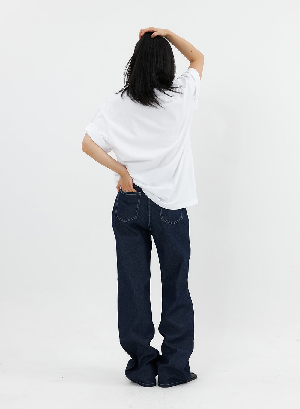 Stitched Jeans OO305 in Blue, back view on model, wide-leg dark denim with contrast-stitched back pockets, paired with white oversized tee.
