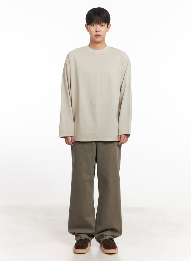 Men's Washed Long-Sleeve T-Shirt IM527 in light beige, full-body front shot on model, relaxed oversized silhouette, styled with wide-leg khaki trousers and dark suede loafers.