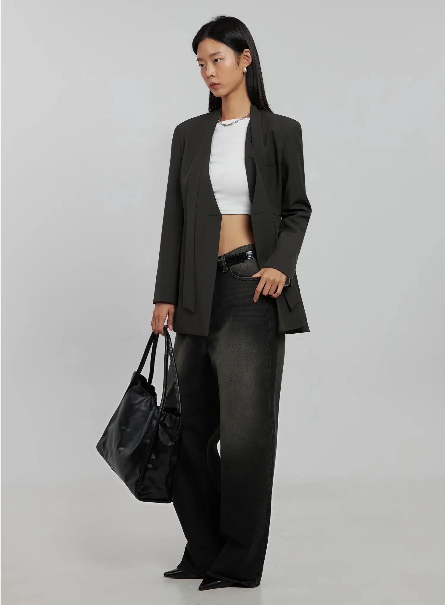 Blaire Dark Washed Wide Leg Jeans IJ509 in black, three-quarter side editorial shot on model, dark washed wide leg silhouette styled with charcoal blazer, white crop top, and black tote bag.